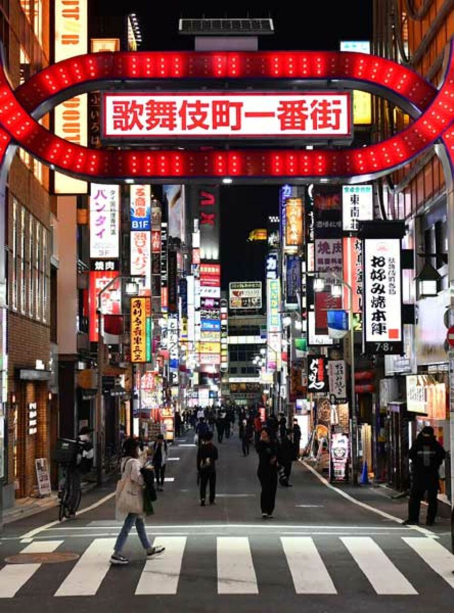  東京・新宿歌舞伎町を歩く人々。東京は延長が濃厚