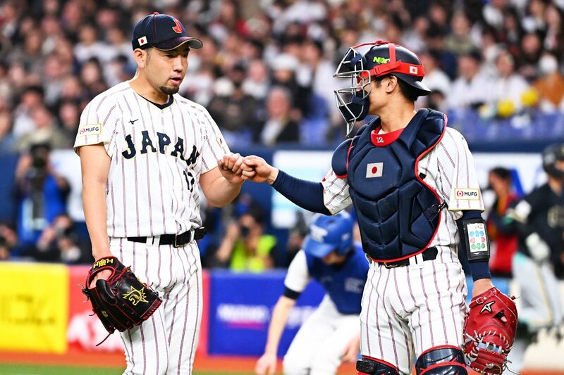 マスクをかぶった阪神・坂本誠志郎(右)に声をかけられるエンゼルス・菊池雄星