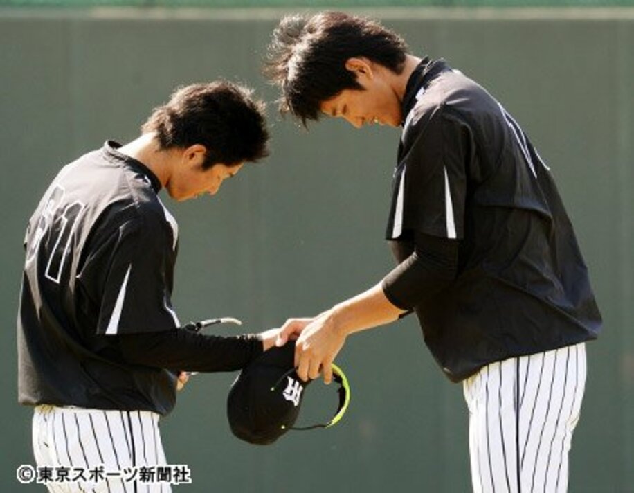 球団を去る田上健一（左）と握手を交わす藤浪