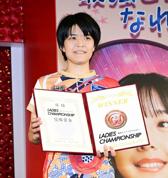 目録を手に笑顔の遠藤エミ