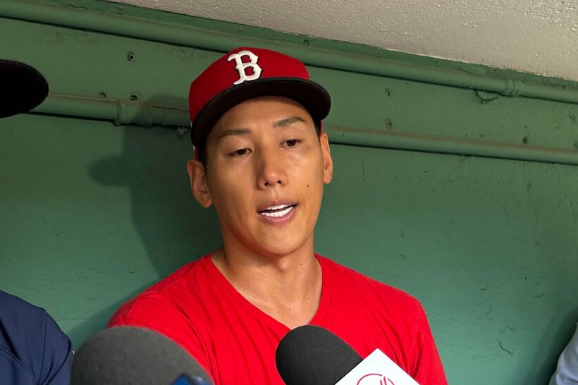 試合前にベンチで囲み取材に応じる吉田