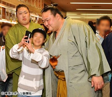  少年ファンの求めに応じ、笑顔で記念撮影する荒磯親方