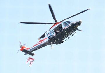 始球式用のボールを投下するヘリコプター