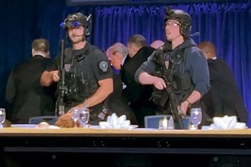 シークレットサービスに誘導され避難するトランプ大統領（ロイター）