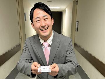 笑顔で名刺を差し出す新橋二郎