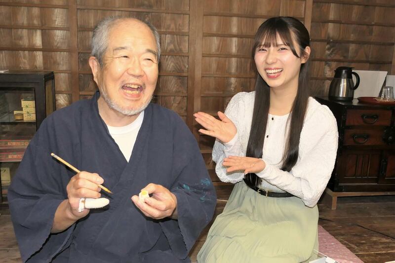 博多人形の伝統工芸士（左）と写真に収まる北川陽彩