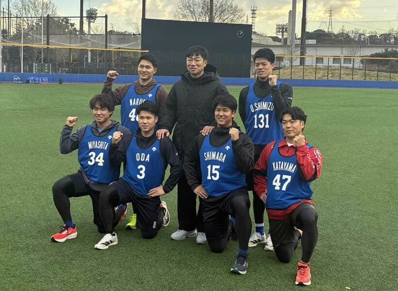 新人選手たちと笑顔で記念撮影に納まる相川監督（中央）