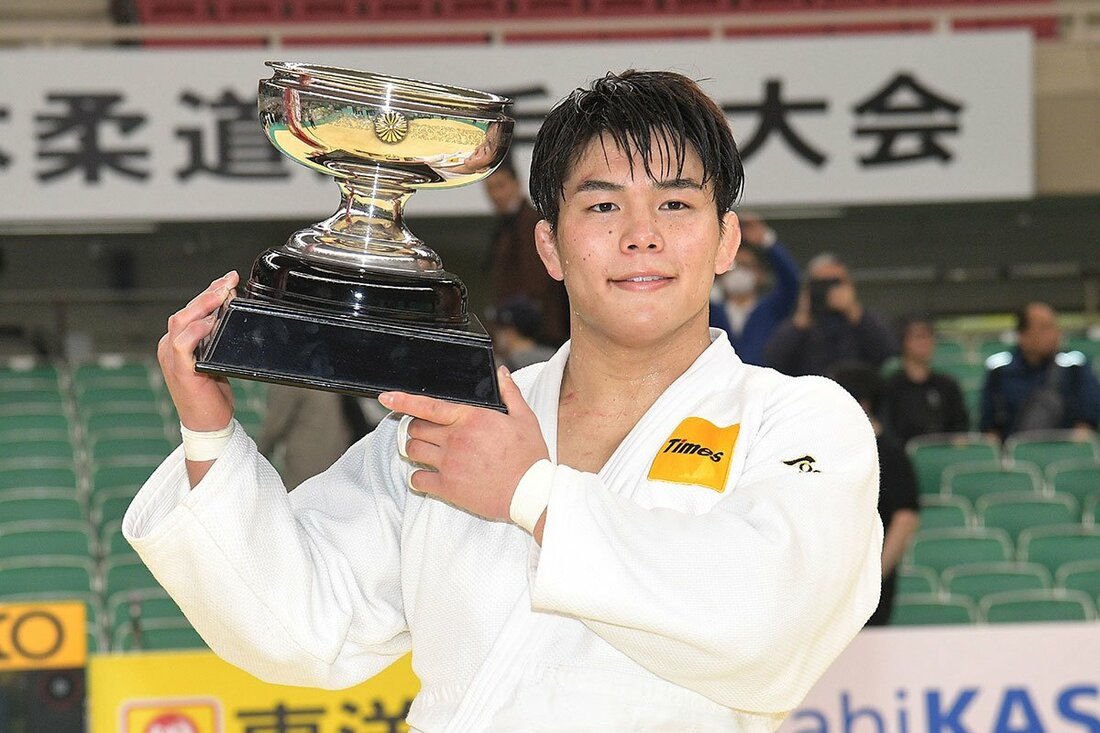 トロフィーを担ぎ、記念撮影する田嶋剛希