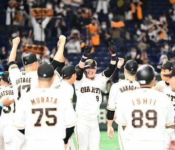  ナインに囲まれ、万歳する巨人・亀井(中)