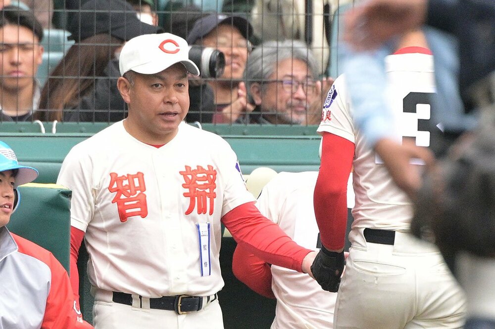 ８回、犠飛を打った逢坂悠誠（右）を出迎える智弁学園・小坂将商監督.
