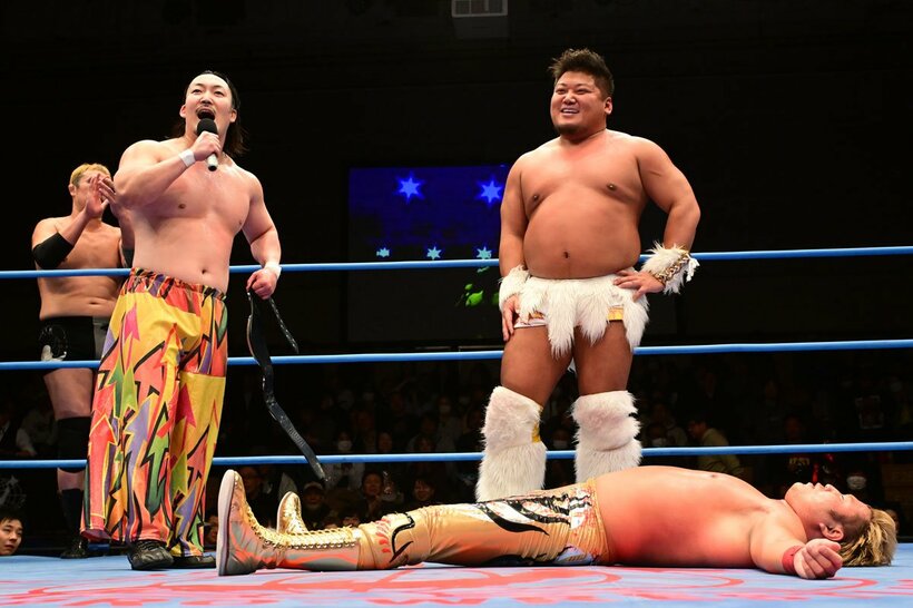 羆嵐（中）からダイブを食らい大の字になる宮原健斗（下）