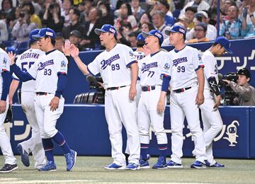 ５月９日の巨人戦で勝利しナインとハイタッチする井上一樹監督（右から２人目）