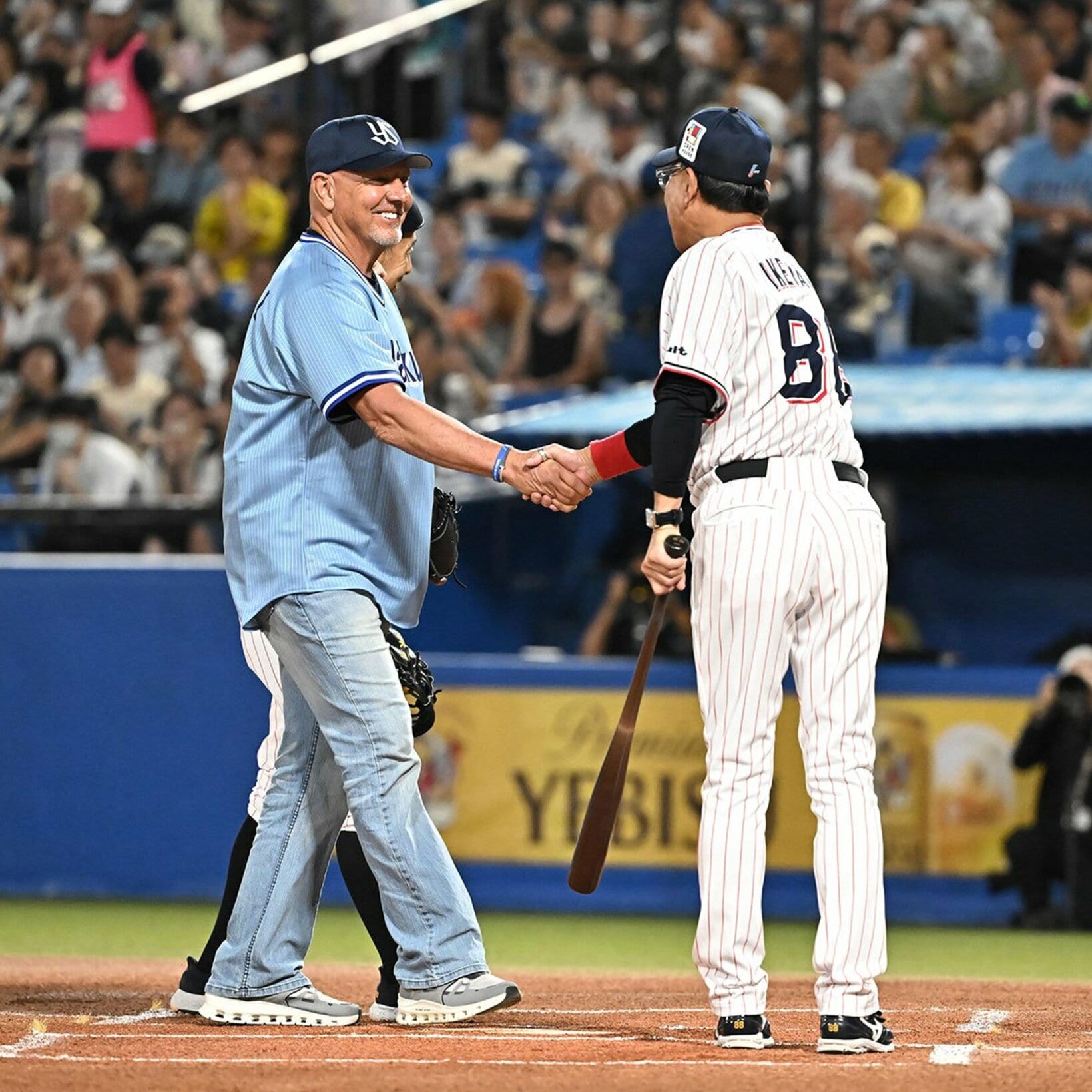 ハウエル氏(左)と握手するヤクルト・池山監督