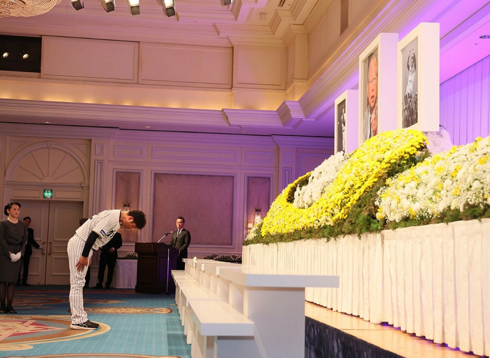 祭壇に献花する阪神・藤川監督(左)