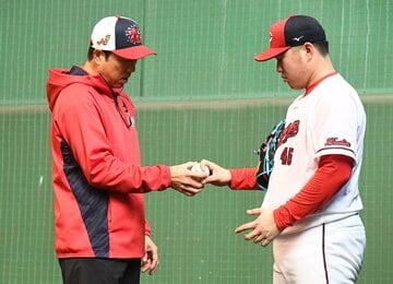 松本（右）にフォークのコツを伝授する黒田氏