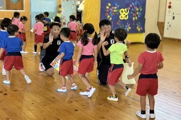 熊本地震復興支援活動で子供たちと交流する武田修宏氏(右)と本田泰人氏