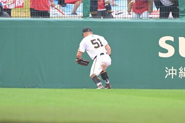 処理を誤った打球を捕りに行く巨人・浅野