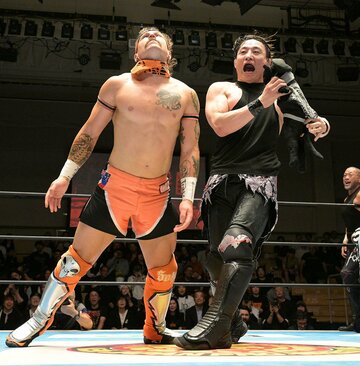 黒いみょんみょん「くろみょん」でロビー・イーグルス(左)をどつくSHO