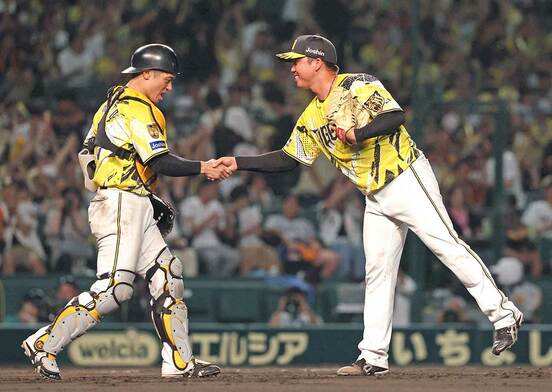 坂本誠志郎(左)と握手する村上頌樹