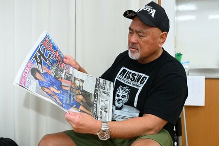 訃報を伝える紙面に目を落とす武藤敬司
