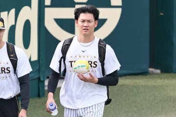 相棒の〝偽ハンドボール〟を持ってグラウンド入りする阪神・及川雅貴
