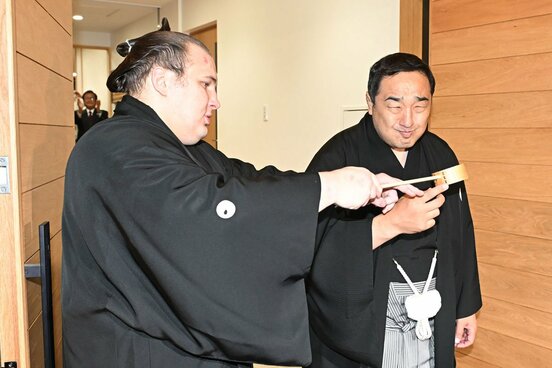 安治川親方(右)に水付けする安青錦