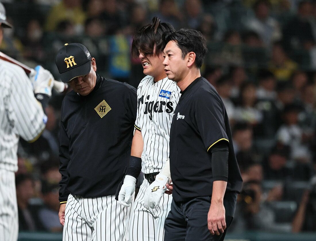 苦悶の表情でトレーナーらとベンチに下がる阪神・前川右京
