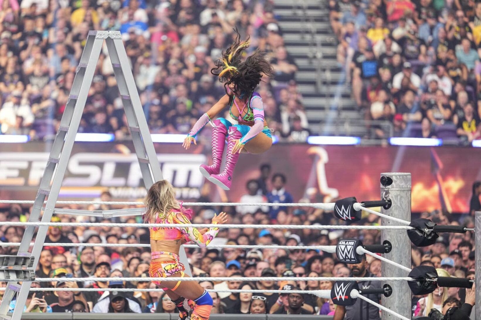 シャーロット・フレアー（下）にミサイルキックを放つチェルシー・グリーン©WWE