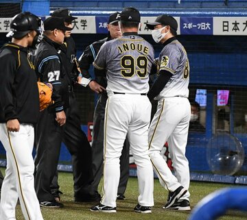  ８回のイニング間に審判団と厳しい表情で話をする阪神・矢野監督（右）