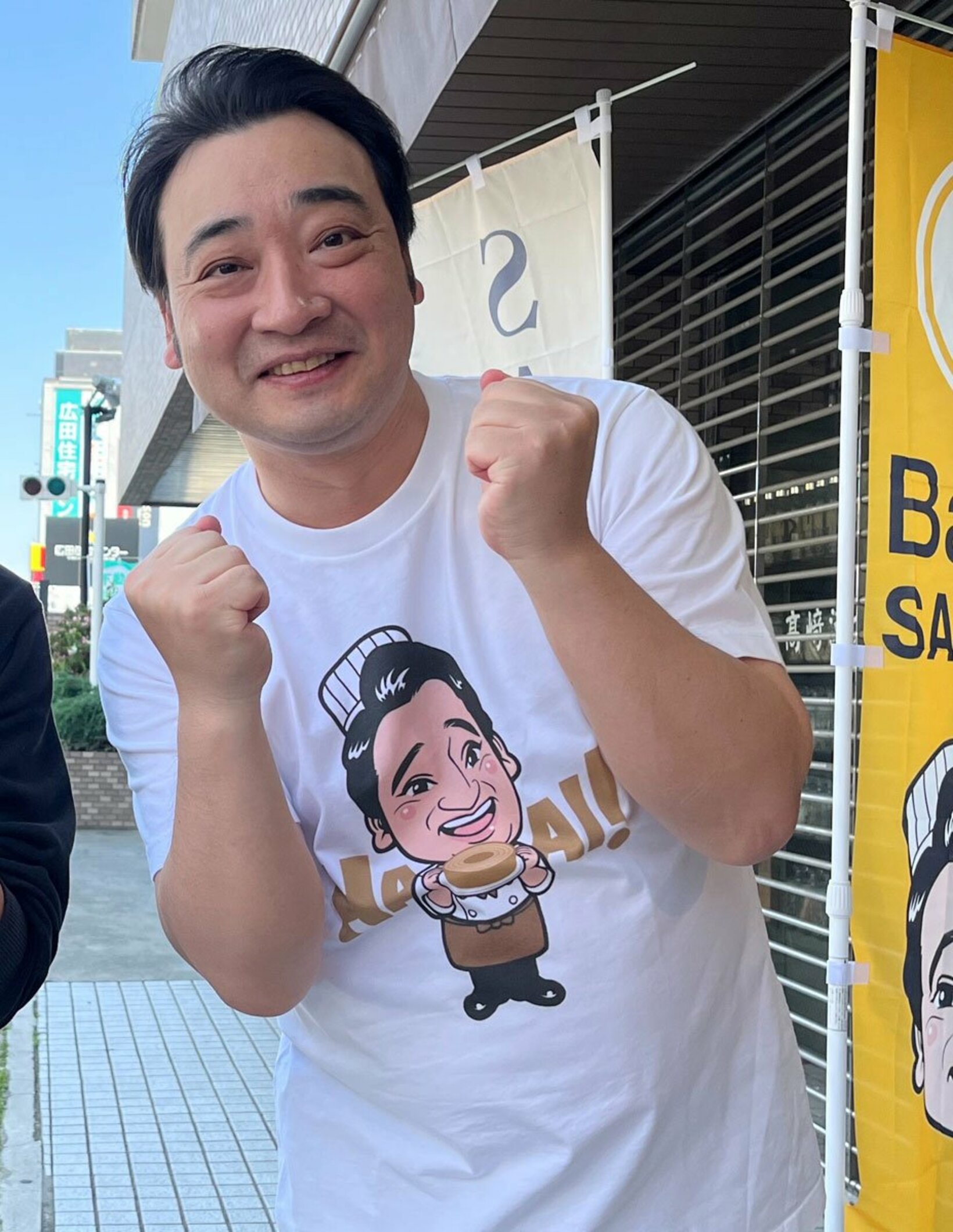 バームクーヘン店ではぁ～い！ポーズを決める斉藤慎二