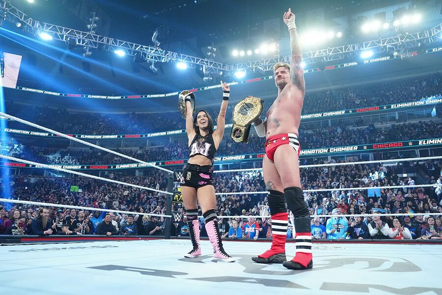 天を指さすCMパンク(右)とAJリーの夫婦（©WWE）