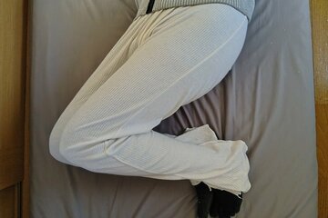 あおむけになってひざを立てた状態から体をサイドにひねるストレッチ